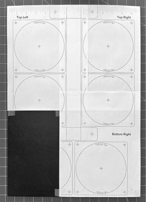 Three template pages taped to the fan panel