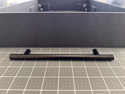 Using the carry handle to mark the hole positions on the top panel.