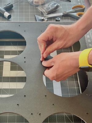 Optional: If it's hard to get the screws through the holes, use a ⅛” or ⁵⁄₃₂” drill bit to enlarge them. Simply hold the bit in your fingers and twist it through each hole.