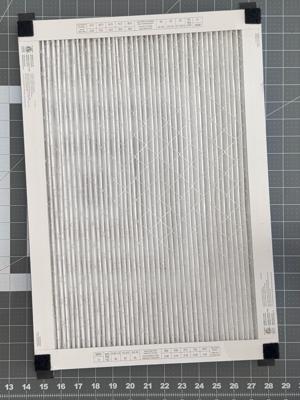 The soft (loop) Velcro patches applied to the corners of the filter.