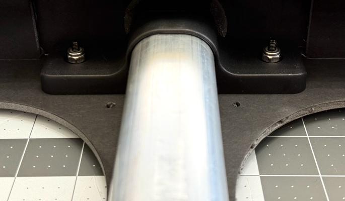 Installing the luggage handle with nuts visible on the inside. Ignore the filter flange for now—you'll install it later.