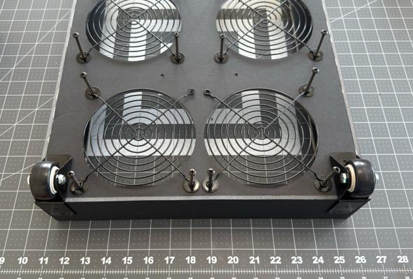 Positioning the wheels on the bottom edge of the air purifier.