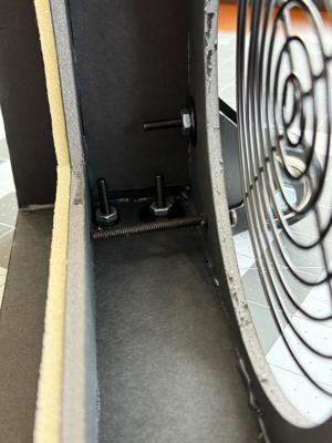 The inside of the air purifier showing the wheel mounting points.