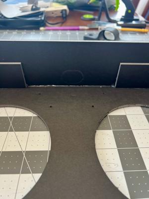 The mark showing where to cut the hole for the telescoping luggage handle.