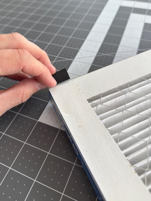 Folding the tape over itself to create the pull tab.